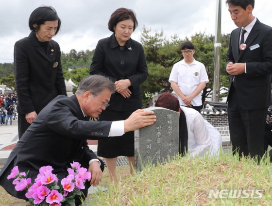 【광주=뉴시스】박진희 기자 = 문재인 대통령과 부인 김정숙 여사가 18일 오전 광주 북구 국립5·18민주묘지에서 열린 '제39주년 5·18민주화운동 기념식'을 마치고 5·18희생자 고 김완봉 묘역을 찾아 참배하고 있다. 고 김완봉(66년 7월 24일부터 80년 5월 21일)씨는 친구와 절을 간다며 길을 나셨다가 사망했고, 어머니는 적십자병원에서 아들 시체를 찾았고 29일까지 아들을 지키다가 묘역에 안장했다. 2019.05.18. pak7130@newsis.com
