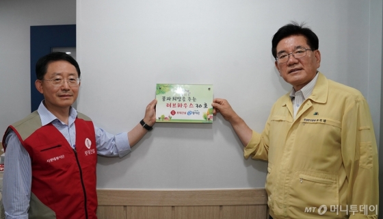 하석주 롯데건설 대표이사(사진 왼쪽)과 유덕열 동대문구청장이 러브하우스 봉사활동을 마치고 기념촬영을 했다. /사진제공=롯데건설