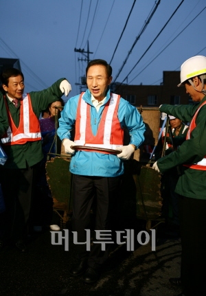 ▲ 쓰레기 수거용 손수레 끄는 李.