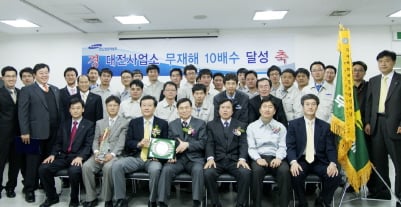 ↑르노삼성자동차 대전사업소가 무재해10배수를 달성해 한국산업안전보건공단으로부터 인증을 받았다. 앞줄 왼쪽 3번째 박수홍 르노삼성자동차 영업본부장,4번째 한정렬 한국산업안전보건공단 본부장<br>
<br>
<br>
<br>
