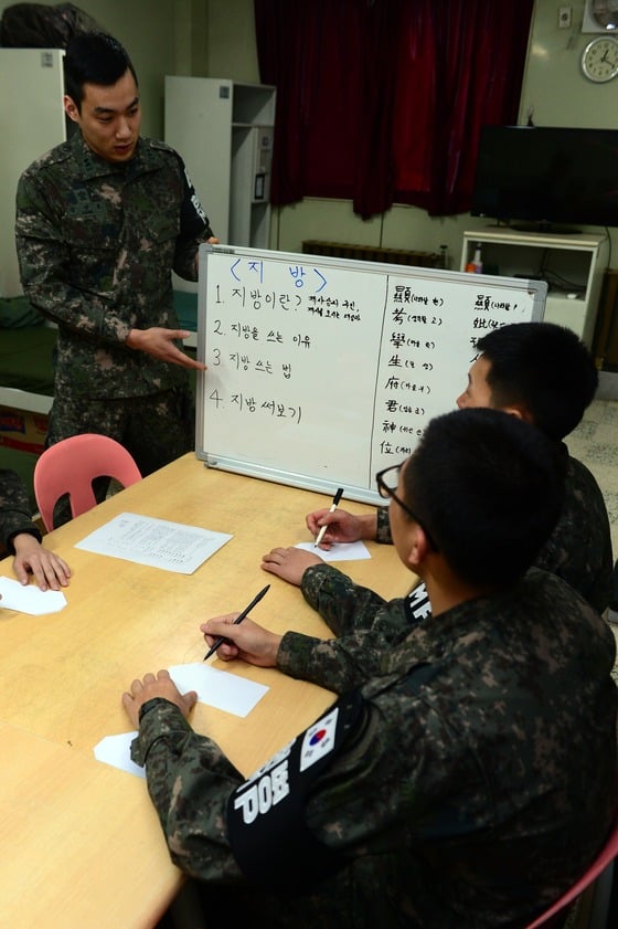  설 명절을 일주일 앞둔 12일 오후 강원 양구군 육군 21사단 병사들이 중동부전선 최전방 GOP소초 생활관에서 지방을 쓰는 방법을 익히고 있다./ 사진=뉴스1