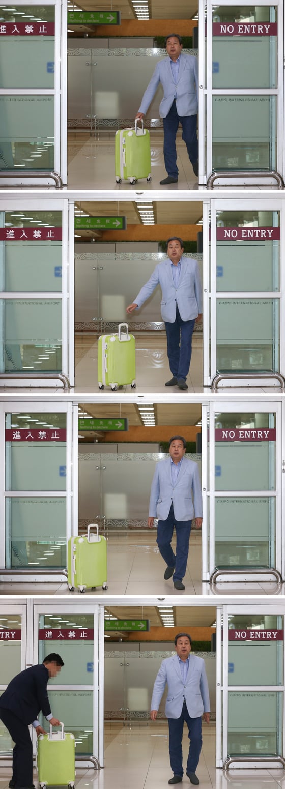  지난 17일 일본으로 출국했던 김무성 바른정당 의원이 23일 서울 김포공항을 통해 입국하며 짐가방을 수행원에게 밀어보내고 있다. /사진=뉴스1