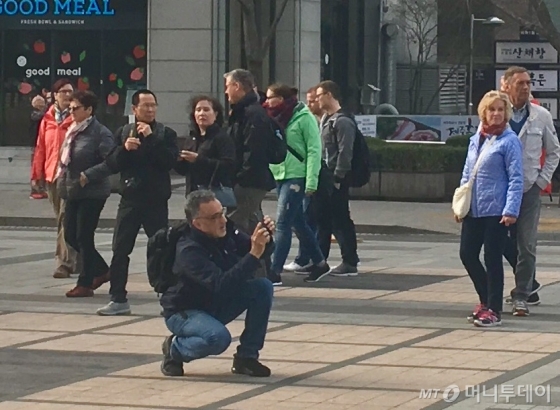 고농도 미세먼지가 전국을 덮은 지난 25일 오전 서울 종로 청계광장을 찾은 외국인들이 여행을 즐기고 있다. /사진= 남형도 기자