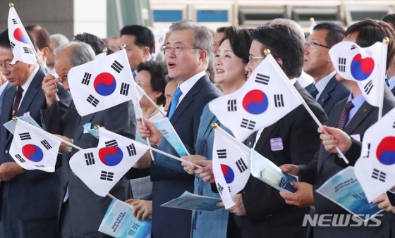 【서울=뉴시스】전신 기자 = 문재인 대통령과 부인 김정숙 여사가 지난해 8월15일 서울 용산구 국립중앙박물관 열린마당에서 열린 제73주년 광복절 및 정부수립 70주년 경축식에서 태극기를 흔들며 광복절 노래를 제창하고 있다. 2018.08.15. photo1006@newsis.com