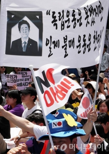 14일 오후 서울 종로구 옛 일본대사관 앞에서 열린 제 1400차 일본군 성노예제 문제 해결을 위한 정기 수요집회에 참석한 시민들이 피켓을 들고 구호를 외치고 있다. /사진=김휘선 기자