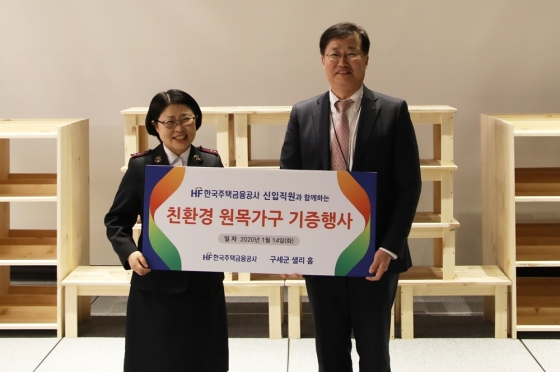 정재선 주택금융공사 상임이사(오른쪽)가 14일 부산 전포대로 아바니 센트럴에서 현은숙 구세군 샐리 홈 센터장에게 친환경 원목가구를 전달 후 기념촬영을 하고 있다. / 사진제공=주택금융공사<br>