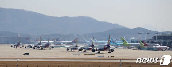 (인천공항=뉴스1) 신웅수 기자 = 16일 인천국제공항 활주로에 항공기들이 계류되어 있다.  정부가 신종 코로나바이러스 감염증(코로나19) 직격탄을 맞은 항공업계에 대한 추가 지원 방안을 조만간 발표하겠다는 뜻을 밝혔다.  항공업계는 전 세계적으로 한국발 입국 제한 조치가 늘어나고 있어 항공사별 자구책만으로 위기를 극복하기에는 역부족인 상황이다.  국적 항공사들의 국제선은 사실상 '셧다운' 상태로 2월 국제선 여객 수는 전년 동월 대비 47% 줄었다. 2020.3.16/뉴스1   