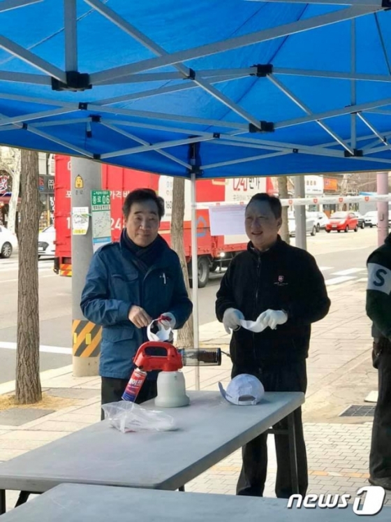 이낙연 전 국무총리(좌측)와 박용만 대한상공회의소 회장이 지난 21일 서울 종로의 한 거리에서 신종 코로나바이러스 감염증(코로나19) 봉사활동 중 만났다. 이 전 총리는 손잡이 소독작업을 하고 있었고, 박 회장은 결식아동에 전할 구호품 박스를 포장 중이었다.(사진=박용만 회장 페이스북)© 뉴스1