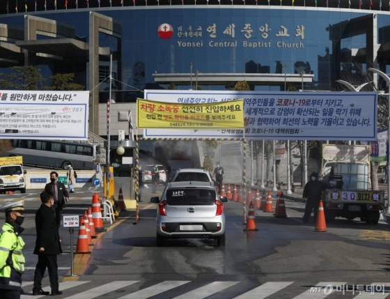 [서울=뉴시스] 조수정 기자 = 신종 코로나 바이러스 감염증(코로나19) 집단 감염으로 인한 지역사회 확산을 막기 위해 정부가 종교 행사 및 집회 중단을 권고했음에도 불구하고 22일 오전 예배를 강행한 서울 구로구 연세중앙교회 차량 출입구로 차량들이 진입하고 있다. 연세중앙교회 관계자는 이날 정문 앞에서 취재중인 기자들에게 보도자료를 배포하며 성도들에게 최대한 온라인 예배를 부탁하고 있으며 성전에서는 출입 성도간 2미터 간격을 유지하는 등 코로나19 확산 방지에 최선을 다하고 있다고 밝혔다. 사회적 거리 유지하기, 마스크 착용 의무화, 발열 체크, 소독, 교회내 방역, 교회 내 음식 섭취 금지 등 국가가 장려하는 7가지 감염예방 수칙을 철저히 준수하고 있으며 해외 혹은 대구 경북 지역 방문, 확진자 접촉 등을 한 사람들과 고위험군(65세 이상, 임산부, 미취학 아동, 장애인, 기저질환자)은 교회 코로나19 대책위원회에 자가격리 보고서를 제출하고 30일간 자가격리 하며 온라인 예배를 하고 있다고도 전했다. 2020.03.22.   chocrystal@newsis.com