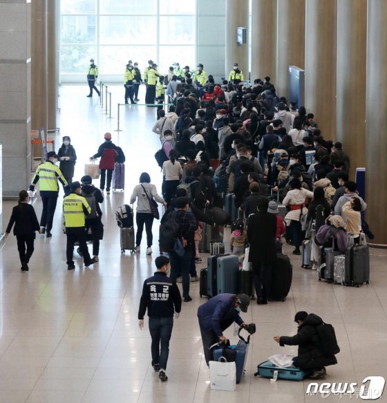 (인천공항=뉴스1) 김진환 기자 = 24일 인천국제공항 1터미널에서 독일 프랑크푸르트발 여객기를 타고 입국한 승객들이 신종 코로나바이러스 감염증(코로나19) 진단 검사를 받기 위해 이동하고 있다. 2020.3.24/뉴스1