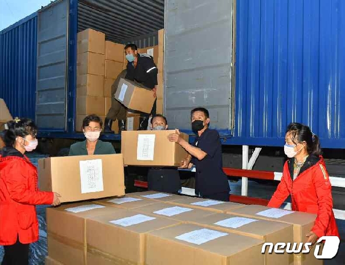 [사진] 수해 지역에 도착한 필수 물자 옮기는 북한 주민들