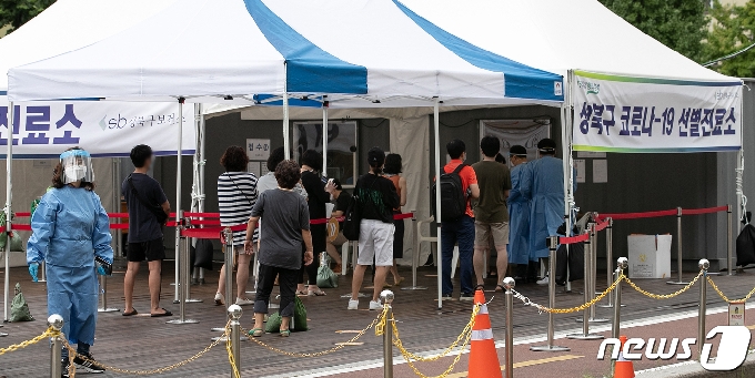 신종 코로나바이러스 감염증&#40;코로나19&#41; 신규 확진자 수가 이틀 연속 300명대를 기록하는 등 확산세가 이어지는 가운데 지난 22일 서울 성북구 성북구청 앞에 마련된 선별진료소에서 시민들이 검사를 받기 위해 대기하고 있다./뉴스1 &copy; News1