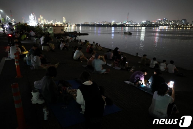 (서울=뉴스1) 이광호 기자 = 코로나19 확산 방지를 위해 주요 한강공원 내 밀집지역에 대한 시민 출입이 통제된 8일 저녁 서울 마포구 한강공원망원지구가 많은 시민들로 북적이고 있다.     서울시 한강사업본부는 이날 오후 2시부터 여의도, 뚝섬,반포 등 주요 한강공원 내 밀집지역의 시민 출입을 통제했다. 공원별 통제 구역은 여의도공원 이벤트 광장과 계절광장, 뚝섬 자벌레 주변 광장, 반포 피크닉장1,2이다. 또한 한강공원 내 매점 28곳과 카페 7곳은 오후 9시에 문을 닫으며, 11개 한강공원 내 43개 주차장도 오후 9시 이후에는 진입할 수 없다.2020.9.8/뉴스1