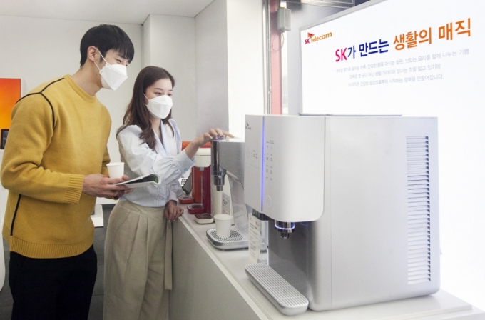 사진은 SKT 고객이 SKT 매장에서 SK매직 렌탈 제품의 구독 관련 상담을 하는 모습.