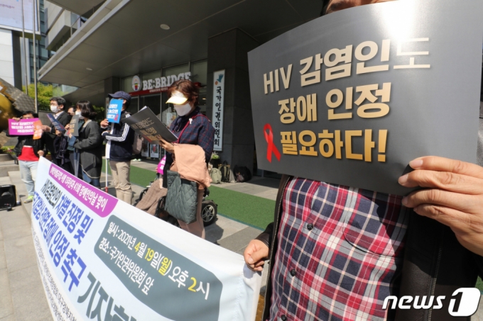 레드리본인권연대 회원들이 19일 서울 중구 국가인권위원회 앞에서 HIV감염인의 차별 진정 및 장애인차별금지법상 전면 장애 인정 촉구 기자회견을 하고 있다. /사진=뉴스1     