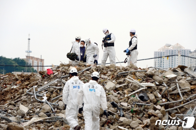 (광주=뉴스1) 정다움 기자 = 10일 오후 광주 동구 학동 재개발지역 건물 붕괴 현장에서 국과수 관계자들이 합동감식을 진행하고 있다. 전날 철거 중이던 5층 건물이 붕괴되면서 주행 중이던 시내버스가 매몰, 9명이 사망하고 8명이 부상을 입었다. 2021.6.10/뉴스1