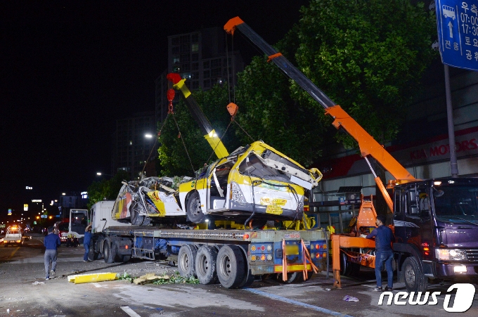 10일 오전 12시30분쯤 광주 동구 학동 재개발지역 건물 붕괴 사고 현장에서 붕괴된 건물에 매몰됐던 45인승 시내버스가 대형 트레일러에 인양되고 있다. 해당 버스는 소속 회사인 대창운수 차고지로 이송될 예정이다.2021.6.10/뉴스1 © News1 정다움 기자