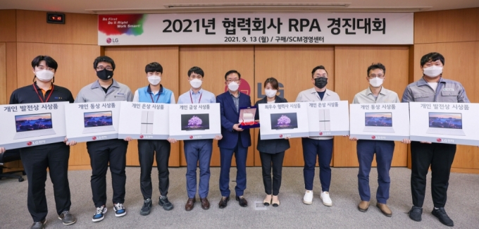 LG전자가 지난 13일 경남 창원시 창원R&D센터에서 화상회의 형식으로 협력회사 RPA 경진대회를 열고 협력사들과 우수사례를 공유했다. 협력사들은 RPA를 개발해 생산, 품질, 영업, 인사, 개발 등 다양한 분야에 도입하며 업무 효율을 높이고 있다. 김병수 LG전자 동반성장담당(왼쪽에서 다섯 번째), 김유숙 엠에스이 대표이사(네 번째) 등이 기념촬영을 하고 있다./사진제공=LG전자