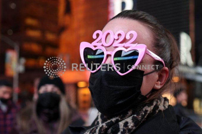 A person wears 2022 glasses ahead of New Year&#039;s Eve celebrations in Times Square as the Omicron coronavirus variant continues to spread, in the Manhattan borough of New York City, U.S., December 31, 2021. REUTERS/Hannah Beier