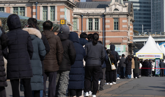 신종 코로나바이러스 감염증(코로나19) 신규 확진자가 9만5362명 발생한 21일 오전 서울 중구 서울역광장에 마련된 임시선별진료소를 찾은 시민들이 검사를 받기 위해 줄을 서 있다. /뉴스1