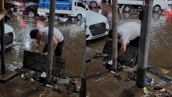 서울 강남구에 쓰레기로 막힌 배수관을 한 남성이 치우고 있다. /사진=트위터