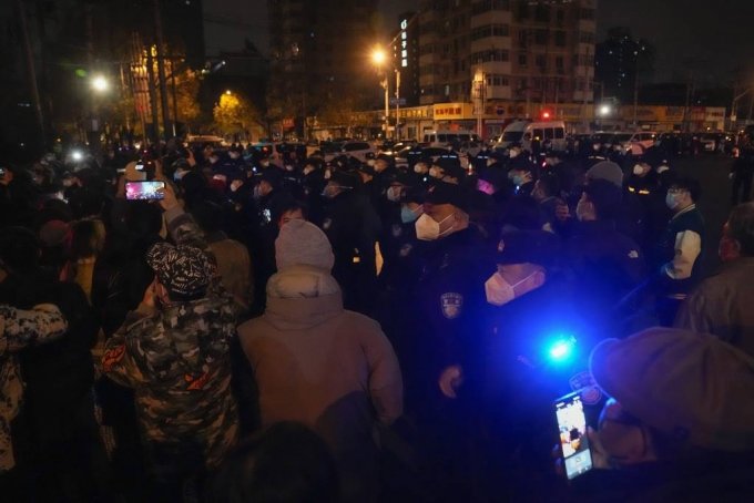 [베이징=AP/뉴시스] 27일 중국 베이징에서 코로나19 봉쇄 정책에 항의하는 시위대가 경찰과 대치하고 있다. 시민들은 정부에 항의하는 의미를 담은 ‘백지’를 들고 28일 새벽까지 시위를 이어갔다. 2022.11.28.