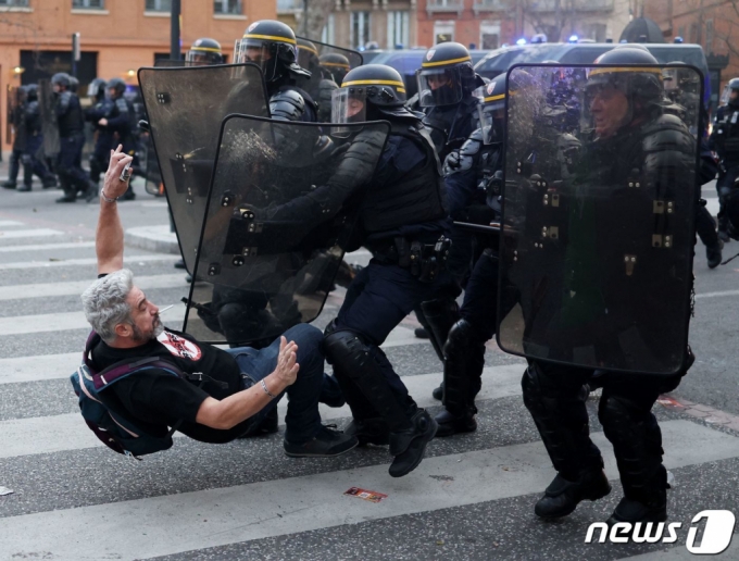 23일(현지시간) 프랑스 툴루즈에서 연금 개혁을 추진하면서 헌법 제49조 3항을 사용해 하원 표결을 건너뛴 에마뉘엘 마크롱 대통령 정부에 항의하는 시위대가 경찰에 연행되고 있다. /AFPBBNews=뉴스1