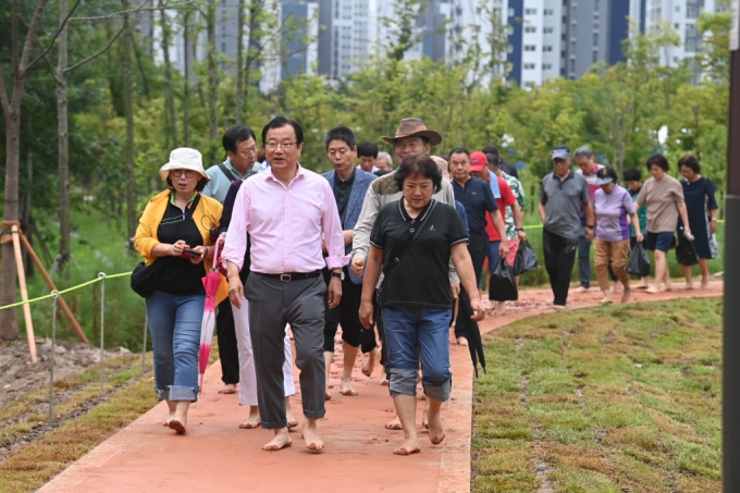 이현재 하남시장이 미사한강5호공원 내 구산둘레길을 점검하며 150여명의 시민과 함께 황토산책길을 맨발로 걷고 있다./사진제공=하남시