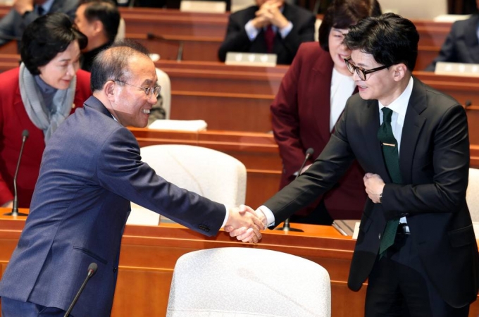 윤재옥 국민의힘 원내대표와 <BR>한동훈 법무부 장관이 6일 오후 서울 여의도 국회에서 열린 국민의힘 정책의원총회에서 악수를 하고 있다.<BR> 2023.12.06. /사진=뉴시스