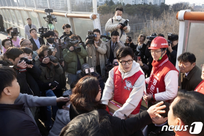 (수원=뉴스1) 송원영 기자 = 철도 지하화 공약을 발표한 한동훈 국민의힘 비상대책위원장이 31일 경기 수원시 천천동보도육교에서 지역 주민과 동행하며 애로 사항을 청취하고 있다. (공동취재) 2024.1.31/뉴스1  Copyright (C) 뉴스1. All rights reserved. 무단 전재 및 재배포,  AI학습 이용 금지.