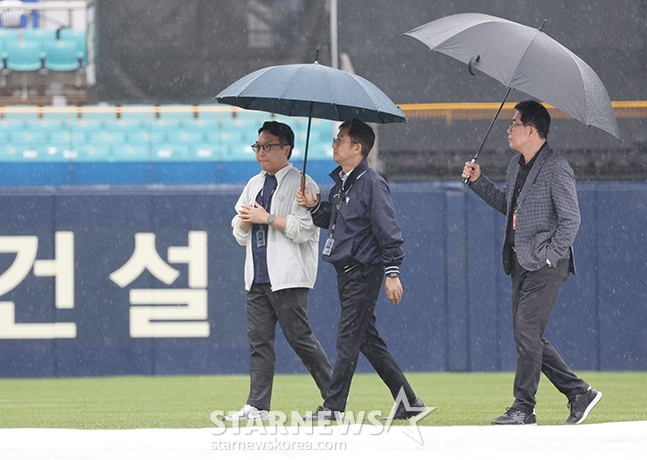 김시진 KBO 경기 감독관(오른쪽)이 14일 PO 2차전을 앞두고 KBO 관계자들과 함께 비 내리는 대구 삼성라이온즈파크를 둘러보고 있다. /사진=김진경 대기자