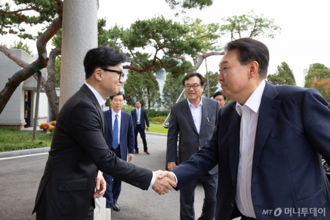 윤석열 대통령이 21일 서울 용산 대통령실 파인그라스 앞에서 한동훈 국민의힘 대표와 인사를 나누고 있다. /사진=대통령실 제공