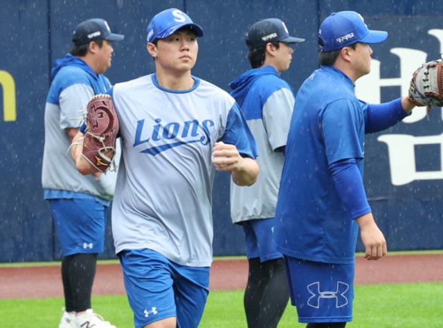 Bae Chan-seung (segundo desde la izquierda) y otros lanzadores de Samsung Lions se entrenan bajo la lluvia el día 25, antes del primer partido de los playoffs (PO) de la postemporada KBO 2026 contra KIA Tigers. /Foto=corresponsal jefe Kim Jin-kyung