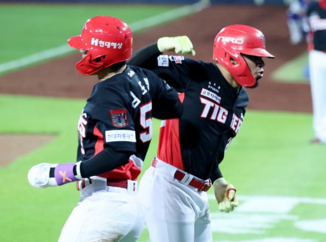 KIAタイガースのヘラルド·カストロ(右)が26日、大邱(テグ)の三星ライオンズパークで行われた三星ライオンズと2026新韓(シンハン)SOLKBOポストシーズンプレーオフ(PO)第1戦の3回表、2ランホームランを放ってホームインした後、金ドヨンとセレモニーをしている。 /写真=キム·ジンギョン待機者