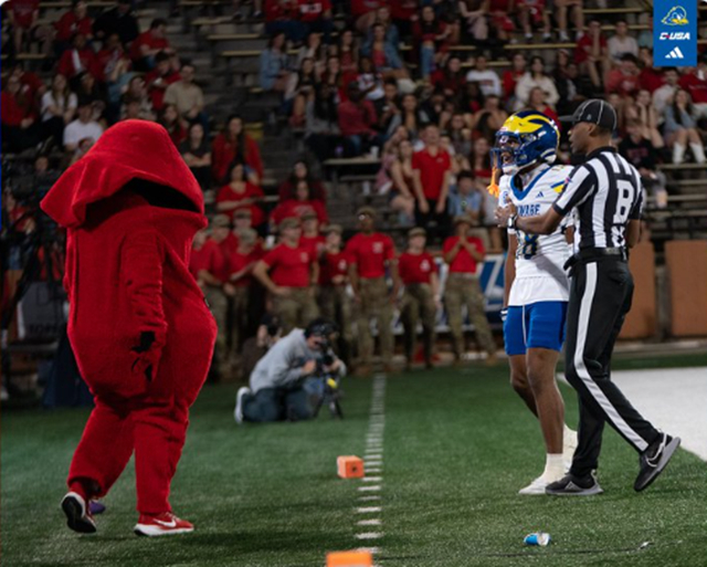 Sean Wilson (right) of the University of Delaware engages in a tense exchange with the opposing team's mascot. /Photo=University of Delaware football team SNS