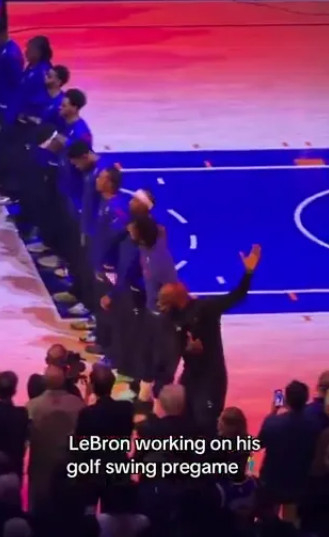LeBron James (right) performing a golf swing motion during the national anthem. /Photo=The Sun