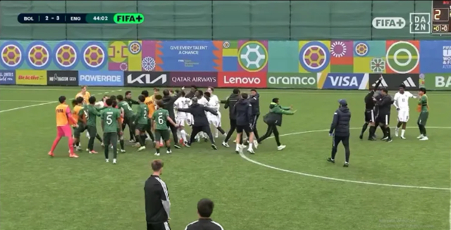 Players and coaching staff from both teams are seen clashing immediately after the end of the 2026 FIFA U-15 World Cup match between England and Bolivia. /Photo=Talk Sports screenshot
