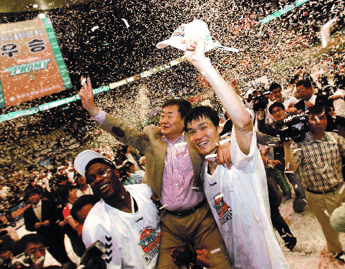 ▲김준기 동부 회장(가운데)이 2007~2008시즌 프로농구 통합우승 후 우승의 주역인 김주성과 오코사가 만든 가마를 타고 관중의 환호에 활짝 웃으며 손을 흔들고 있다.