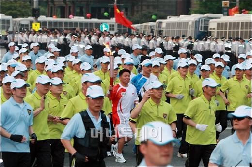 ↑청계광장을 가득 메운 주한 중국인들이 흔드는 홍성홍기를 뒤로하고 2008베이징 올림픽 성화 봉송이 한창이다. ⓒ<임성균 기자 tjdrbs23@>