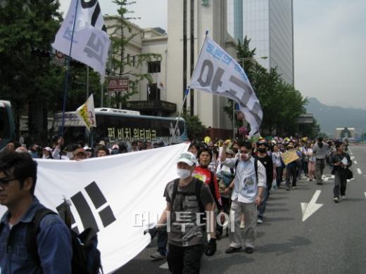↑대형 태극기를 앞세우고 행진 중인 다음 아고라 회원들