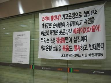 ↑ 전일저축은행 정문은 굳게 닫혀있고 피해자들의 요구사항이 적힌 내용이 걸려있다.