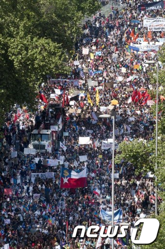 칠레의 수도 산티아고에서 15일(현지시간) 세계적인 행동의 날에 동참한 사람들이 거리 시위를 하고 있다. (사진=AFP)  News1
