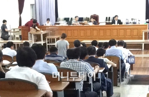 ↑최근 불황 여파로 경매시장엔 매물이 쌓이고 응찰자는 줄어드는 현상이 이어지고 있다. 사진은 경매법정에서 경매 입찰이 진행되는 모습. ⓒ민동훈기자