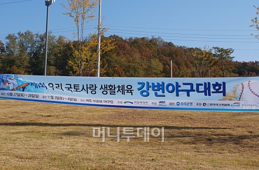 ↑경기 여주 이포보 공원 잔디 위에 걸려 있는 '제1회 우리국토사랑 강변야구대회' 현수막.ⓒ송학주
