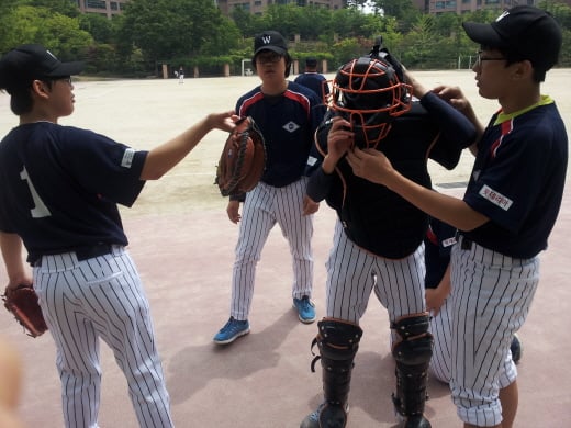 1일 서울 서초구 반포동 원촌중학교에서 서울시교육감배 학교스포츠클럽 야구 원촌중 대 서일중 경기가 열렸다. 원촌중 학생들이 공수교대 중 포수의 장비 착용을 함께 도와주고 있다. /사진=정도원 기자