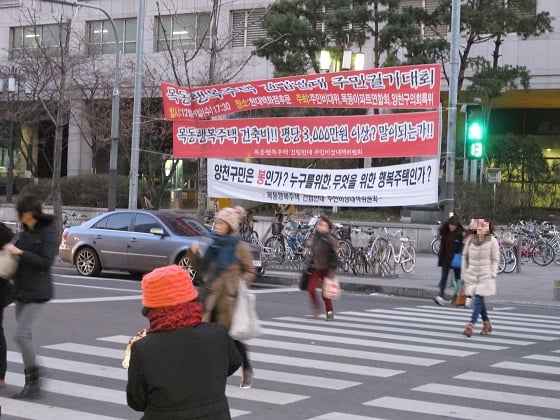 중도위 의결 소식이 있던 지난 19일, 목동 현대백화점 앞으로 주민들이 행복주택 반대 현수막 앞으로 바쁜 걸음을 재촉하고 있다./사진=지영호 기자