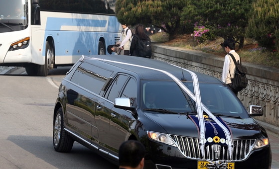 24일 오전 등교하던 단원고등학교 3학년 학생들이 희생자 운구차량을 향해 고개숙여 애도하고 있다. /사진=뉴스1 허경 기자.