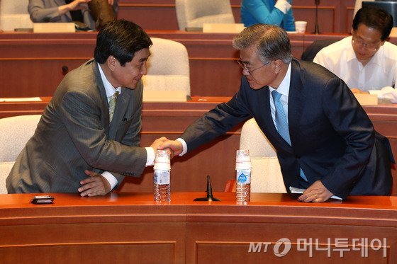 새정치민주연합 문재인 대표와 이종걸 원내대표가 박근혜 대통령이 국회법 개정안에 대해 거부권을 행사한 25일 서울 여의도 국회에서 열린 의원총회에서 악수하고 있다.2015.6.25/뉴스1