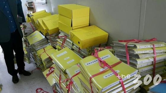 2016년 9월 21일 촬영한 병무청 한 구석에 쌓여 있는 개인정보 화일들.병무청은 이에 대해 스캔 작업을 위해 쌓아둔 것이라고 설명했다. 그러면서 이 문서는 열쇠로 문을 열고 들어가야 하는 문서보관소 안에 있는 것이라며 그냥 방치된 것은 아니라고 해명했다./사진=김학용 의원실 제공