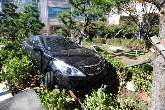 18호 태풍 '차바'가 북상한 5일 오후 부산 해운대구 마린시티 고층아파트에 한 차량이 파도에 휩쓸려 화단에 걸려 있다./사진=뉴스1
